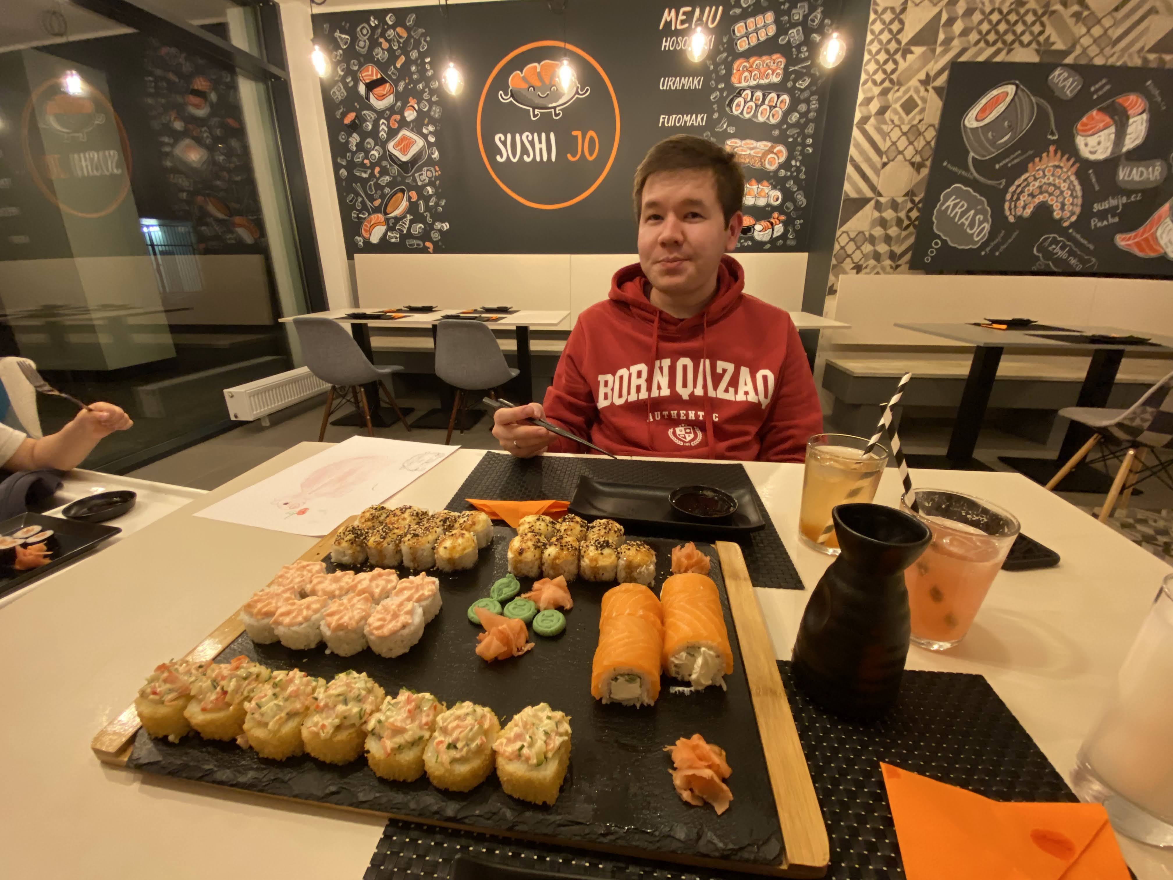 Aibol sitting in a sushi restaurant